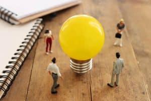 Vier miniatuurfiguurtjes kijken samen naar een lamp, de onderwijsregio's gaan aan de slag met de subsidie