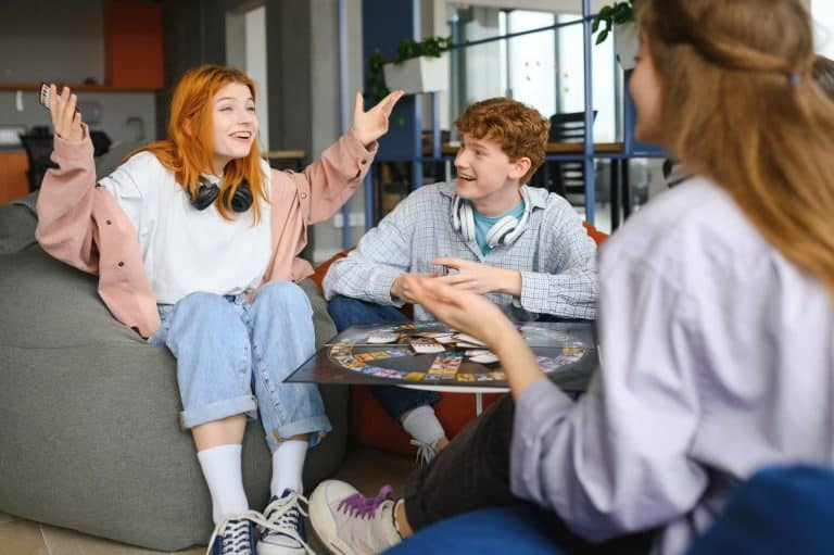 Group of friends having fun while playing board game.